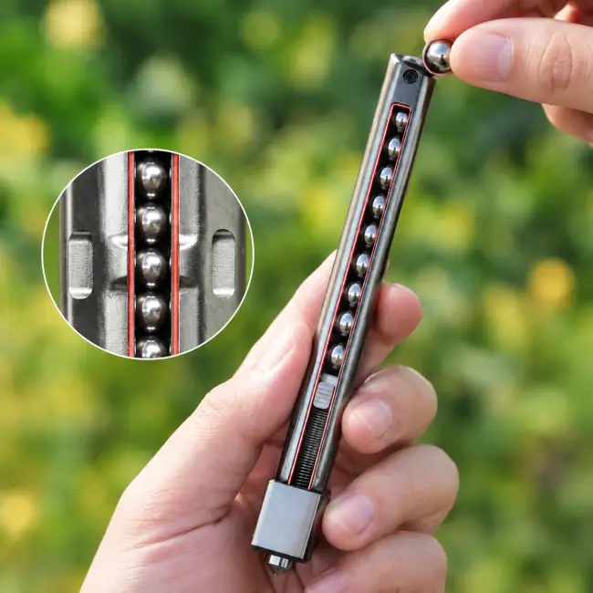 Hand loading steel balls into the magazine of a magazine-fed slingshot